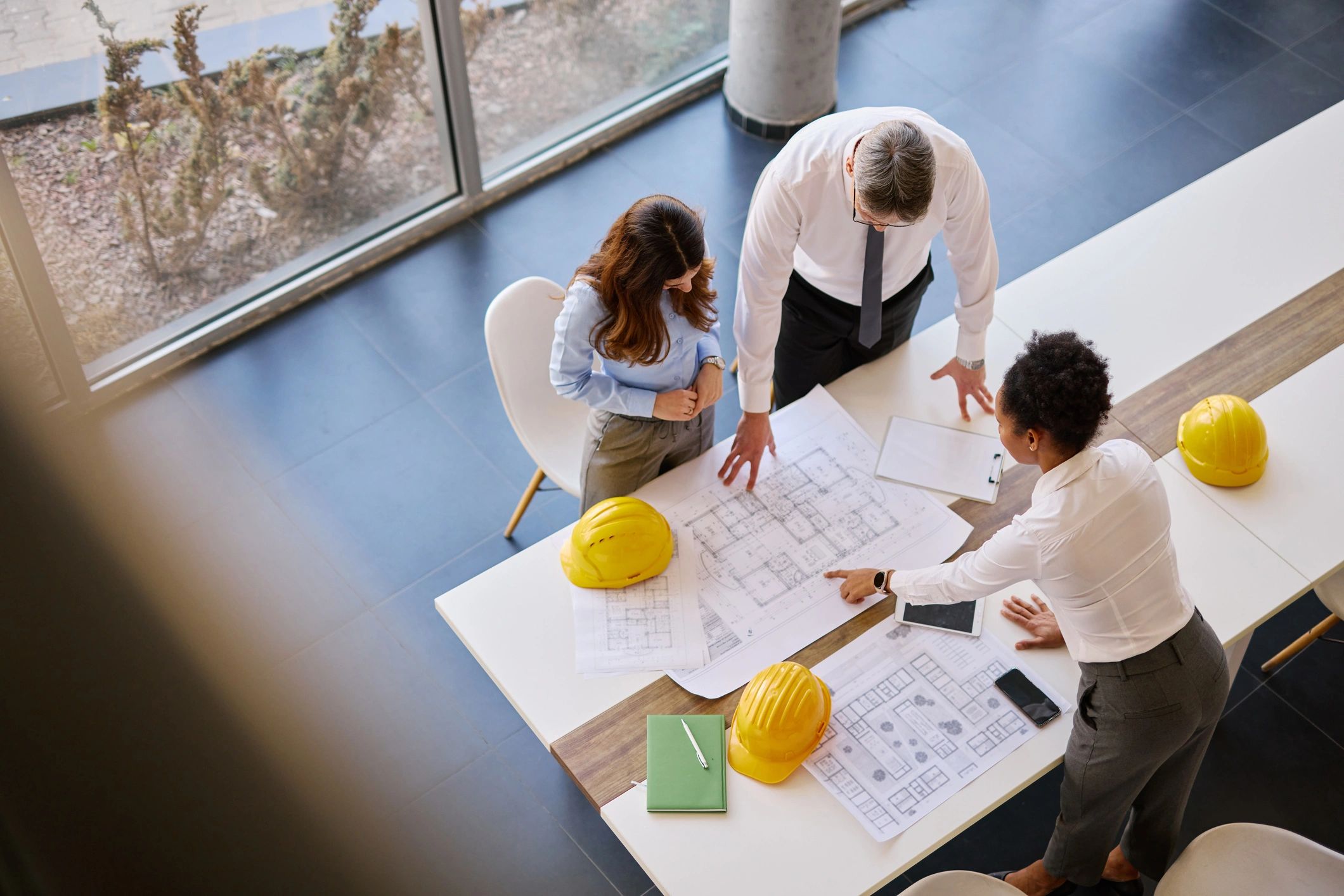Architects reviewing construction plans and project requirements